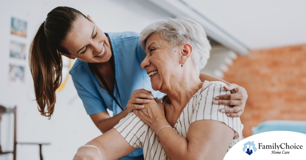A female caregiver helping an older woman with stroke recovery at home.